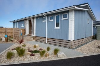 Exterior of luxury lodge with gravel landscaping