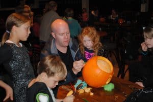 Family carving a pumpkin at Trevornick