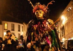 Reveller in mask and costume at Montol mid winter Festival, Cornwall