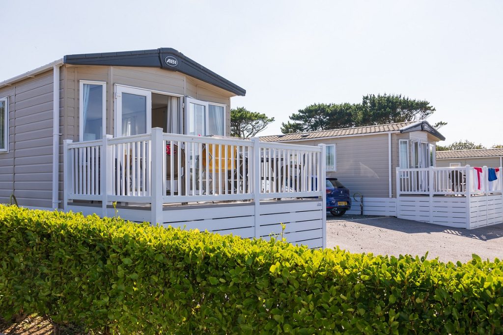 Static caravan from the outside showing the patio doors open