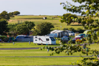 A camping field at Trevornick set up with various caravans and tents for guests on holiday