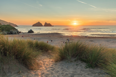 Holywell Bay beach at sunset with Gull Rocks